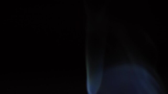 close up of elegant smoke trail curling and twisting in black space. smooth movement represents transformation, fleeting moments and abstract concept. intros, overlays and creative visual content