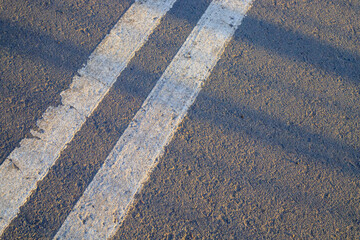 Fototapeta premium Double white dividing strip on the asphalt of the road.
