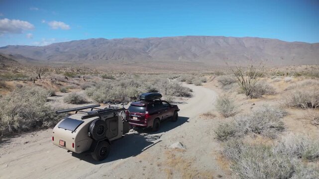 Aerial views show a teardrop camper trailer and SUV exploring trails in Anza Borego Desert State Park and Prune Canyon in California