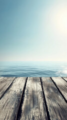 Fototapeta premium Weathered wooden planks lead to tranquil ocean waters under clear blue sky, creating a sense of serenity and inviting escape in a peaceful coastal setting.