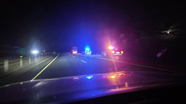 Police Stop Trucker on Highway at Night With Flashing Lights Ahead