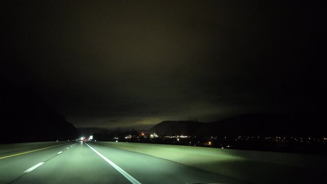 Driving Through the Appalachian Mountains at Night Near Town