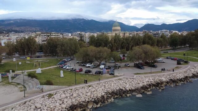 Aerial rotating view of Patras coast with Saint Andrew dome and sea