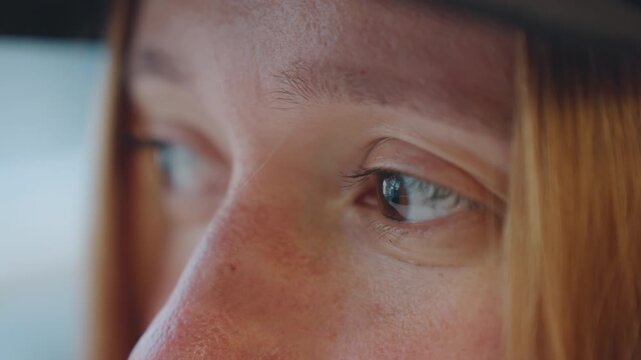 Closeup white woman glancing sideways on car, tense lookout with hat brim and freckles, cinematic shallow depth, urban stakeout atmosphere, watchful eyes scanning crowd, subtle sweat and nervous