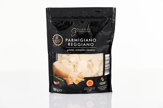 Gourmet Parmigiano Reggiano shaved hard cheese in black pouch packaging photographed on white background. Italian parmesan cheese flakes retail product isolated in clean studio packshot for illustrati