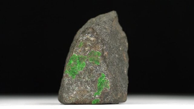 Uvarovite - calcium-chromium silicate mineral, an emerald-green variety of garnet. Small green crystals on the stone surface