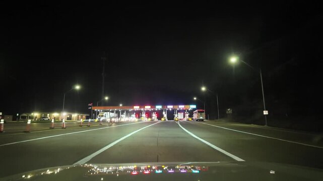 Driving at Night Towards a Toll Road in West Virginia Mountains