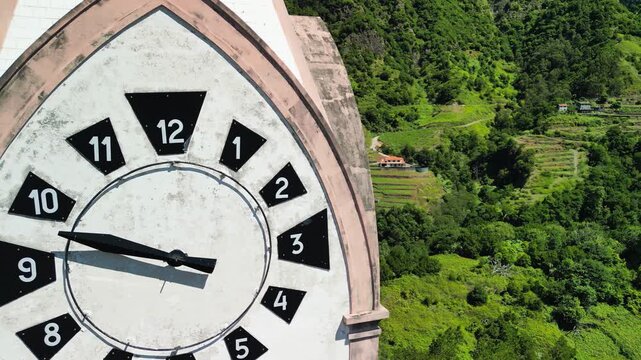 Historic Clock Tower of the Chapel of Our Lady of Fatima on Madeira Island, framed by lush greenery and vibrant architecture