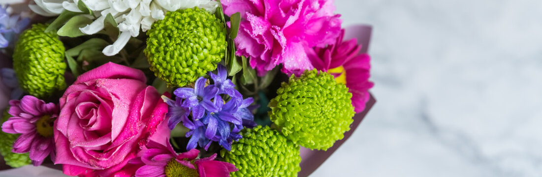 Absolutely gorgeous, multicoloured bouquet in a flower box on marble background.soft pastel floral composition for mother day celebration greeting and holiday. copy space
