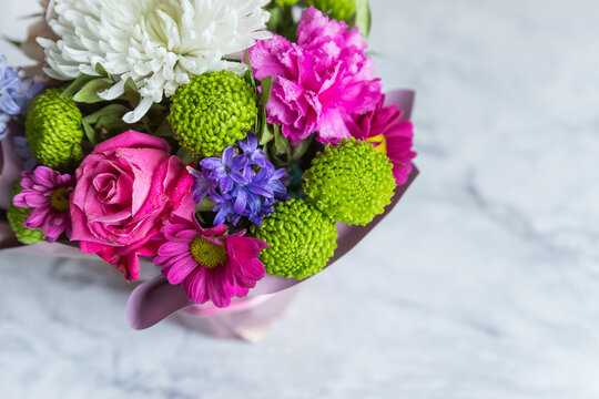 Absolutely gorgeous, multicoloured bouquet in a flower box on marble background.soft pastel floral composition for mother day celebration greeting and holiday. copy space