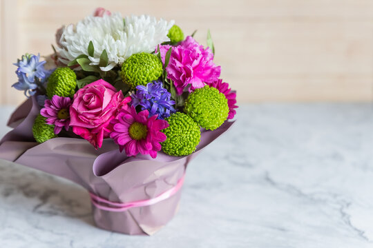 Absolutely gorgeous, multicoloured bouquet in a flower box on marble background.soft pastel floral composition for mother day celebration greeting and holiday. copy space