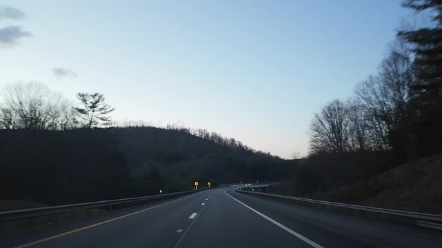 Driving Through Curves in the Appalachian Mountains at Dusk