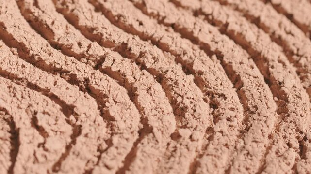 Macro close up of beige face powder texture lines