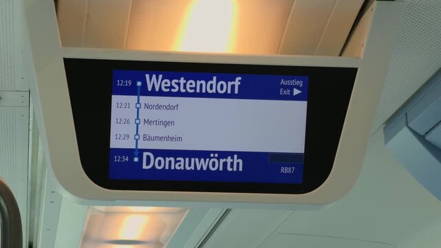 Digital information display on a regional train in Bavaria, Germany. Route from Muenchen to Donauwoerth via Westendorf and Mertingen. Modern passenger transport and railway infrastructure.