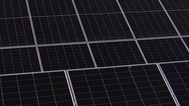 Drone Flying Over Solar Panels Array at Sunset Renewable Electricity