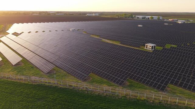 Drone Flyover of Large Solar Power Plant at Dusk Photovoltaic Panels