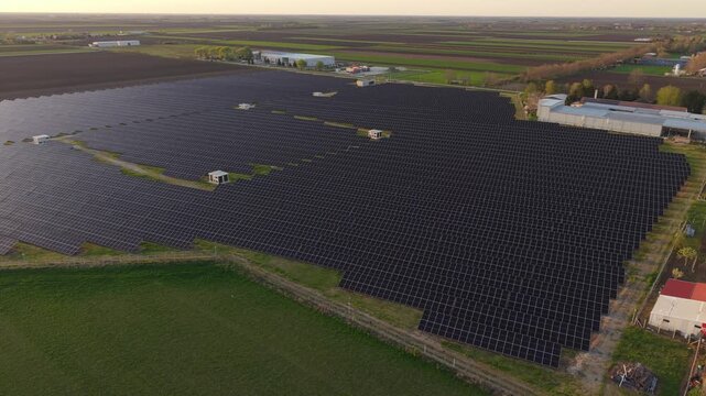 Aerial Drone View of Solar Panel Farm at Sunset Golden Hour Renewable Energy