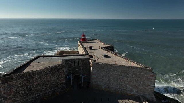 Cinematic Aerial View of Nazare Lighthouse and Calm Atlantic Coast Portugal