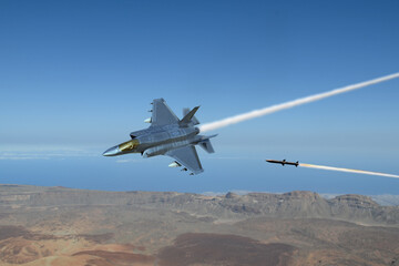 Fototapeta premium A missile attacks a modern fighter jet as it flies over the ground