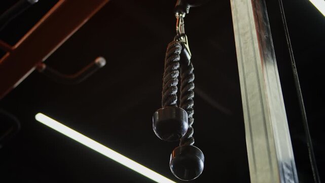 Low angle shot of moving brand new cable pullover machine in gym