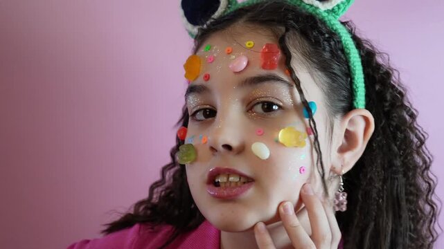 Teenage Female Radiates Playful Selfassurance While Posing With Colorful Decorations And Expressive Lips
