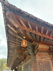 Rustic Natural Log Rafters and Hanging Wooden Lantern on Traditional Korean Buddhist Temple Eaves © BestForYou Photos