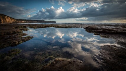 Obraz premium Dramatic Sky Reflected in Rocky Coastal Pool