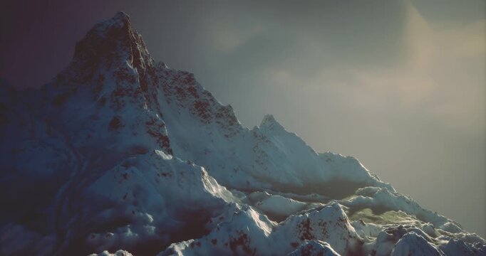 Dusk settles over a rugged mountain range covered in snow. Dark clouds hover above, casting dramatic shadows on the peaks, creating a serene yet powerful atmosphere.