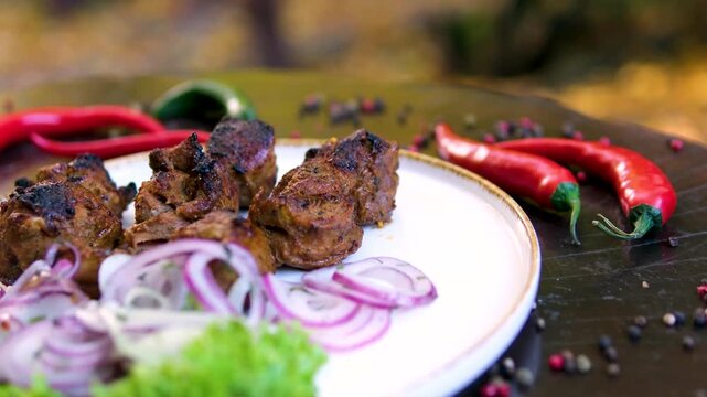 Lula kebab in Mediterranean cuisine with fresh herbs. blue onion, lettuce leaves, red chili pepper, bell pepper, cherry tomatoes