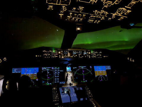 Aurora Borealis visible from flight deck of airliner inflight over North Atlantic Ocean. 