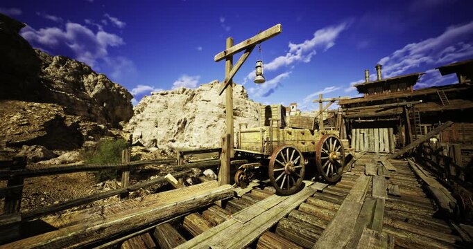 A rustic wooden wagon sits on a weathered bridge surrounded by a rugged desert landscape. The bright blue sky and distant rocky formations create a dramatic backdrop.
