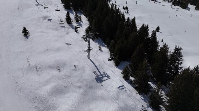 Aerial view of ski lifts in Courchevel ski resort slopes by winter, French alps