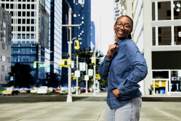 Fototapeta premium Dancing, good news and exulting woman on city street receiving positive school grade. Raving, high college exam marks and overjoyed african american young girl outside celebrating