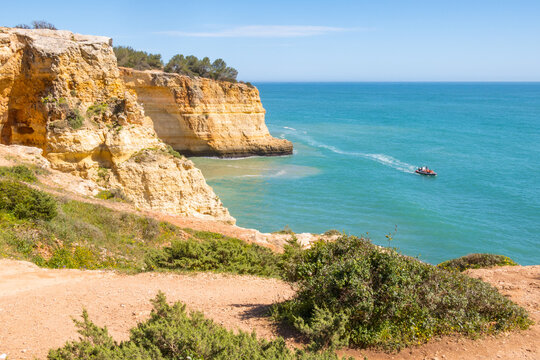 Tourists in a boat near Benagil in Algarve region - Portugal