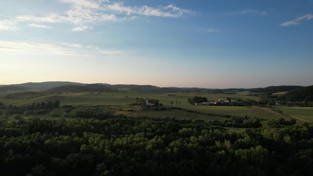 Remote Church of Saint Lawrence at Zdoun in Sumava mountains with cemetery captured as aerial panorama historic religious landmark