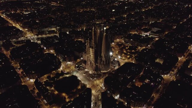 Night aerial view of Sagrada Familia illuminated in Barcelona cityscape