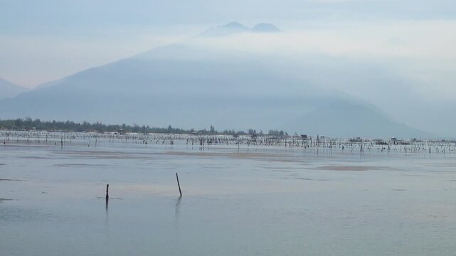 Abandoned nets, poles and aquaculture in the Gulf of Tonkin. Seascape, Vietnam