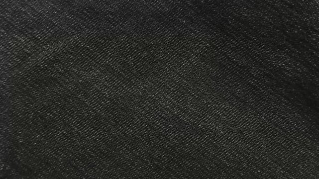 Black, white and grey color fabric sheet or cloth surface with old vintage grain, noise or dots background texture pattern. Fashion business and textile industry abstract stop motion loop animation.