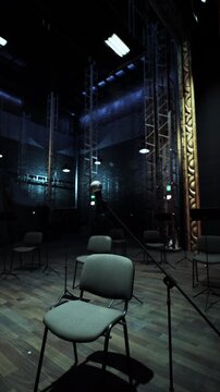 In a dimly lit opera house, empty chairs await the audience as a single microphone stands ready on stage. Soft lights highlight the elegant architecture, creating a sense of excitement.