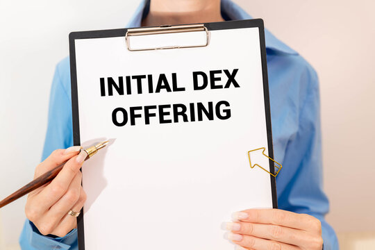 Initial DEX Offering calculator and red notepad. text about business