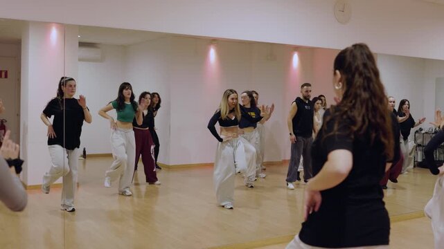 Hip hop dance class learning choreography in a studio