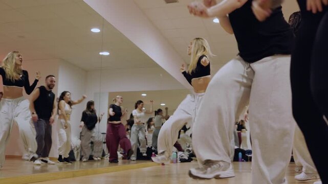 Group of diverse dancers learning choreography in a studio