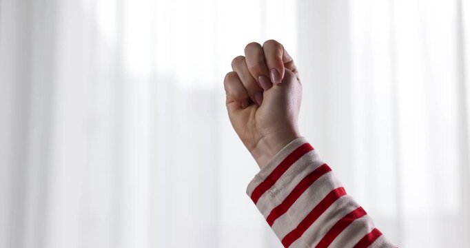 Woman showing signal for help at home, closeup
