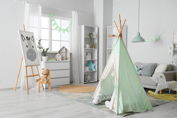 Interior of children's room with tent, sofa and easel © Pixel-Shot
