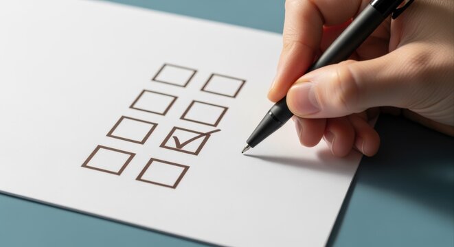 Close up of hand checking off a task on a checklist with a pen, signifying completion and progress