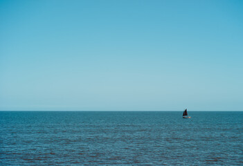 Fototapeta premium small traditional fishing boat on the sea against the horizon