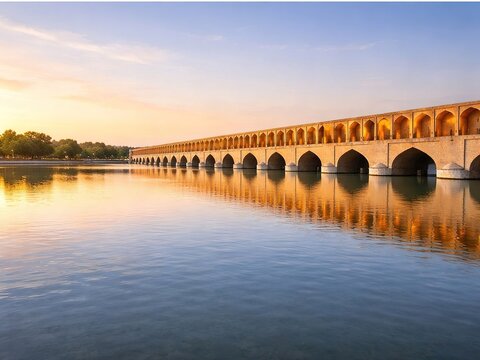 Historic bridge over the Zayanderud River in Isfahan, Iran, Persian architecture reflected in the water, clear sky and ample space for text in horizontal composition