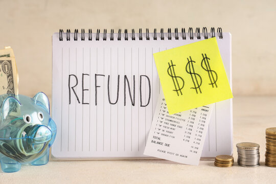 Piggy bank with money, receipt and word REFUND on grunge beige background