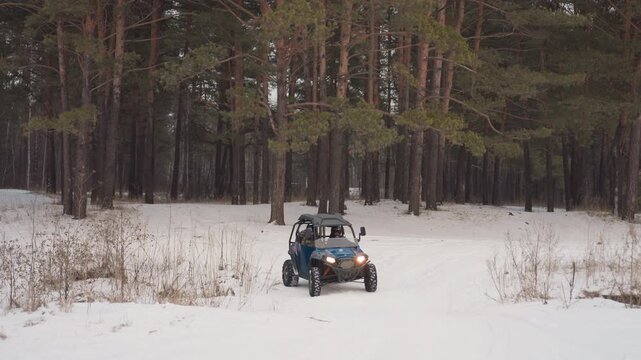 Frozen forest journey. Snowy trail with rider. Nighttime adventure through icy pine woods. Helmeted rider efficiently travels on icy pathway amidst silent snowfall in mountain pine forest