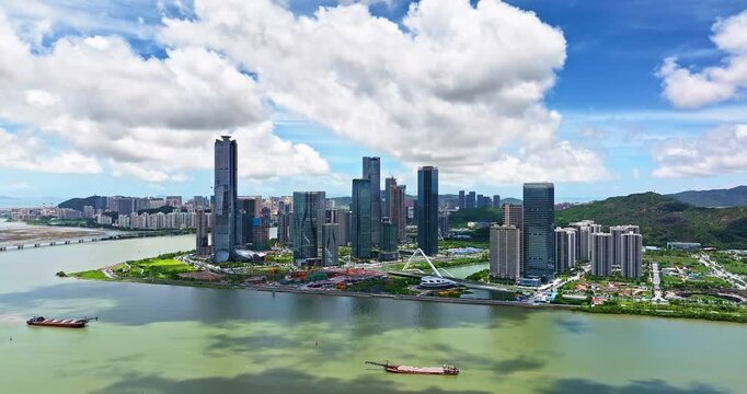 Drone view of modern financial district skyscrapers and city skyline by the river, Zhuhai, China.